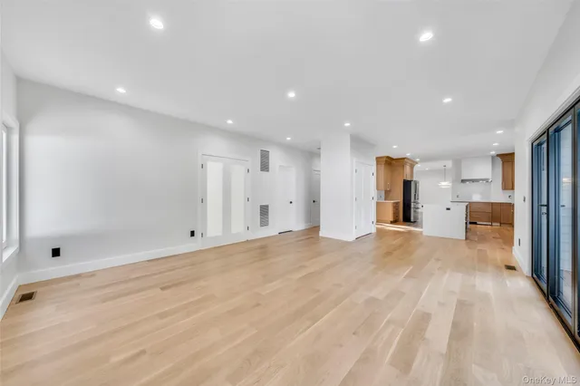 a view of a kitchen with a refrigerator and a sink