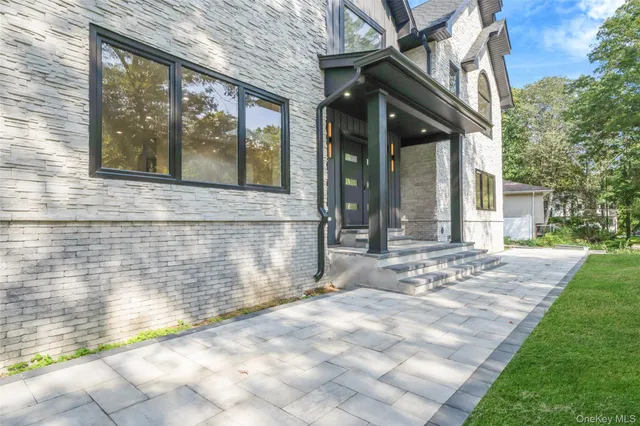 a view of a brick house with a large windows