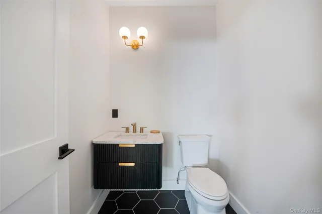 a bathroom with a toilet a sink and mirror