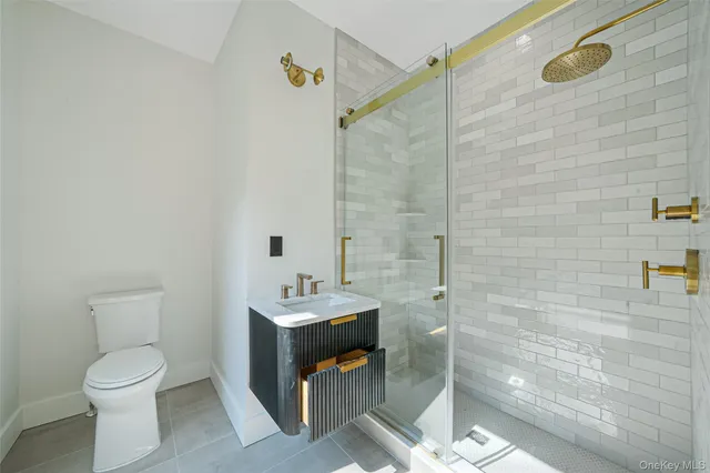 a bathroom with a toilet sink and shower