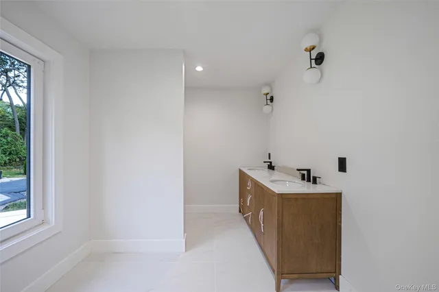 a view of a bathroom with a sink and mirror