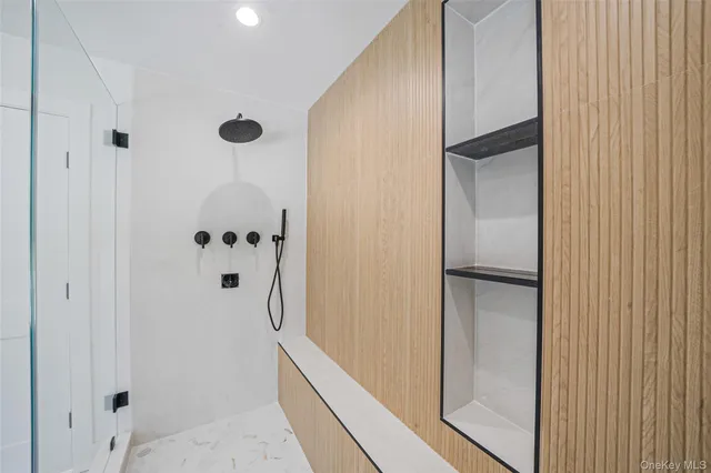 a bathroom with a shower and a mirror