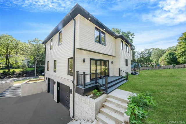 a view of a white house with a yard