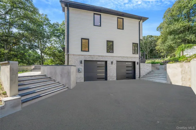 a view of a house with a yard and garage