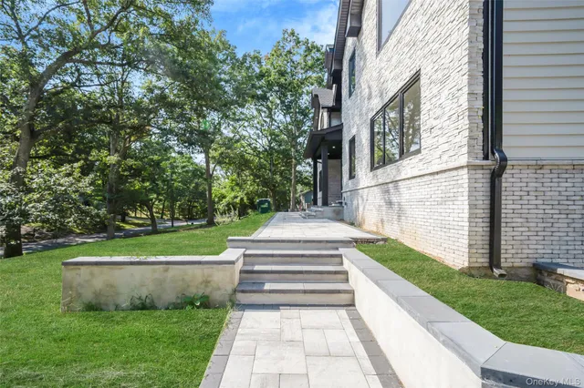 a view of a fountain in front of a white house