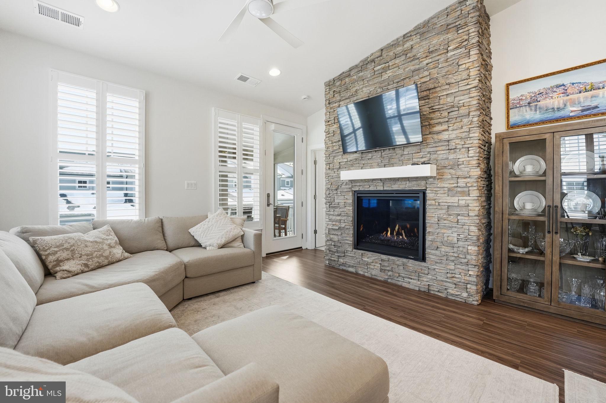151 Windflower Way Stafford, VA 22554 - Photo 18 of 88 a living room with furniture a fireplace and a flat screen tv