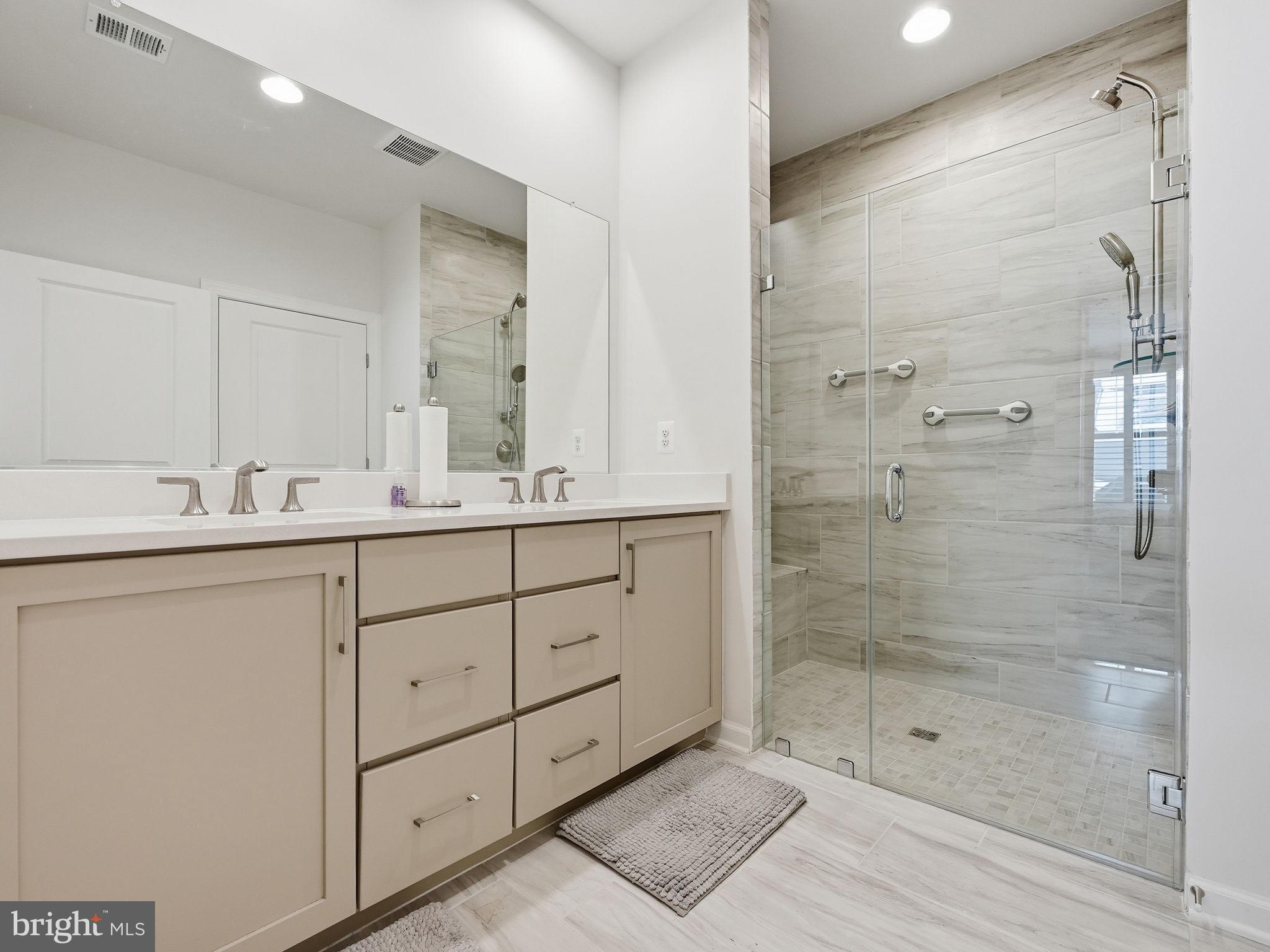 151 Windflower Way Stafford, VA 22554 - Photo 28 of 88 a bathroom with a shower sink and mirror