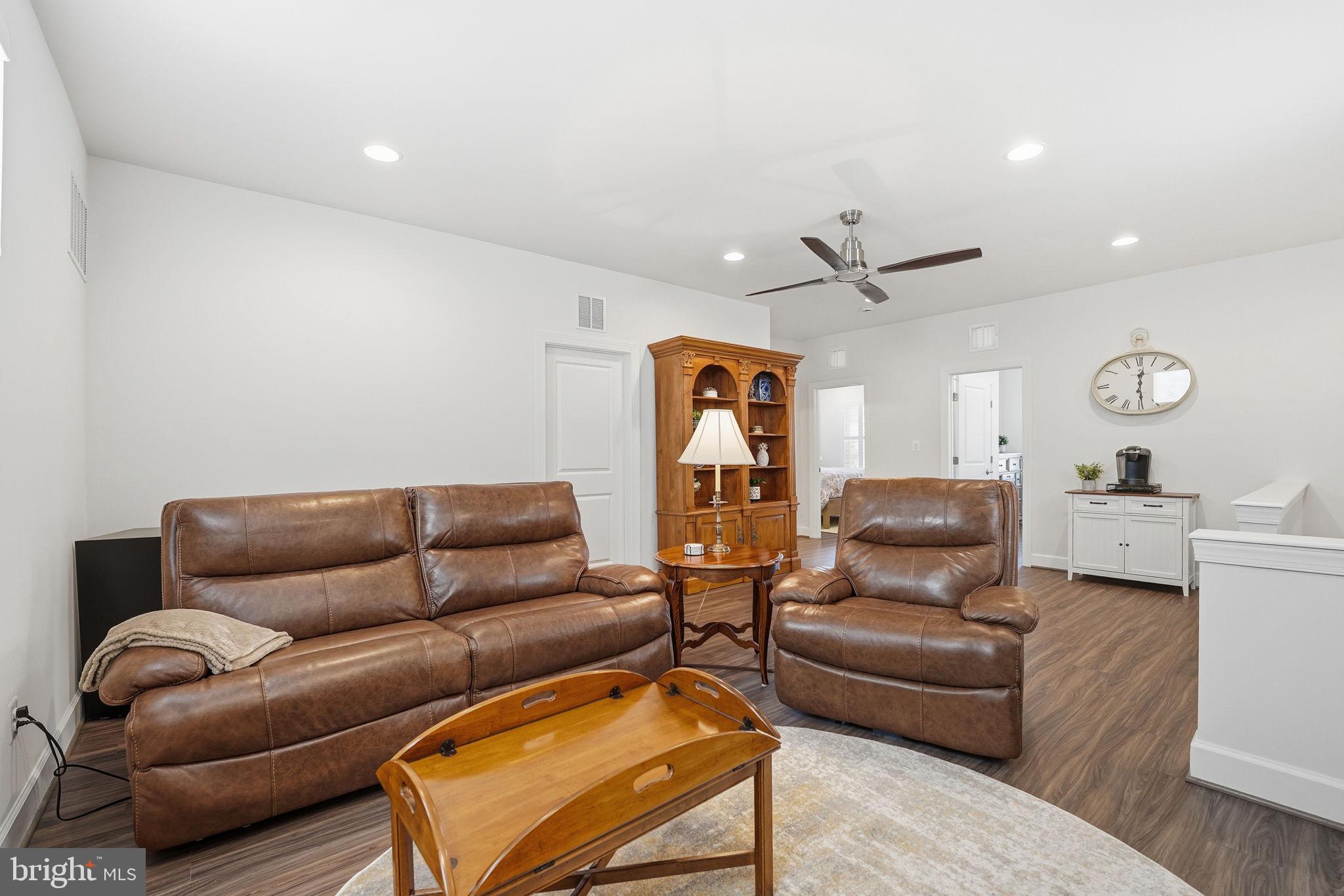 151 Windflower Way Stafford, VA 22554 - Photo 34 of 88 a living room with furniture a ceiling fan and a rug