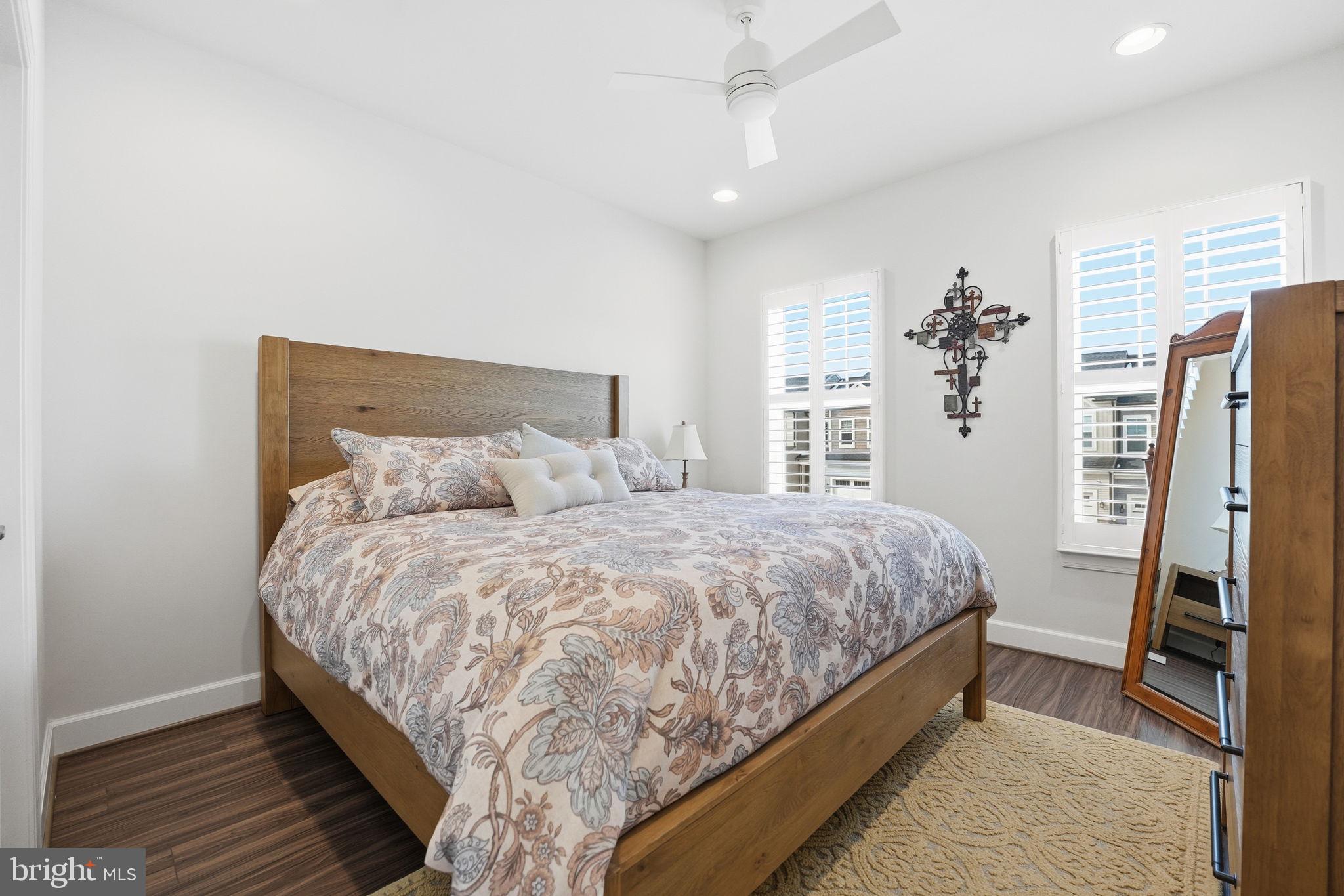 151 Windflower Way Stafford, VA 22554 - Photo 39 of 88 a large bed sitting in a bedroom next to a window and a flat tv screen