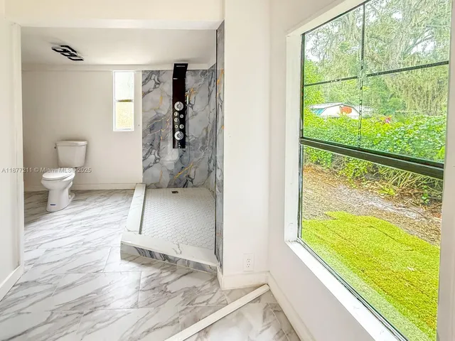 a bathroom with a sink toilet and shower
