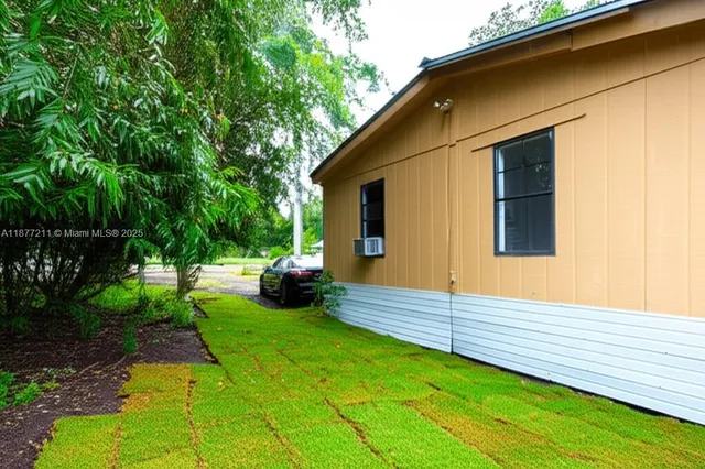 a view of backyard of house with green space