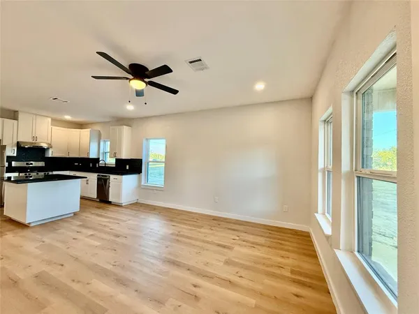 a view of kitchen with refrigerator and microwave