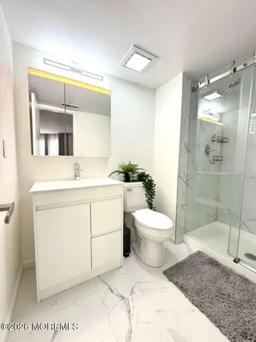 a bathroom with a sink a toilet and mirror