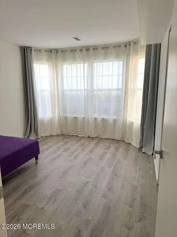 a view of bedroom with furniture and wooden floor