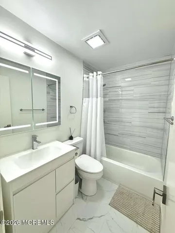 a bathroom with a sink a toilet and mirror