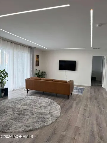 a living room with furniture and a kitchen view