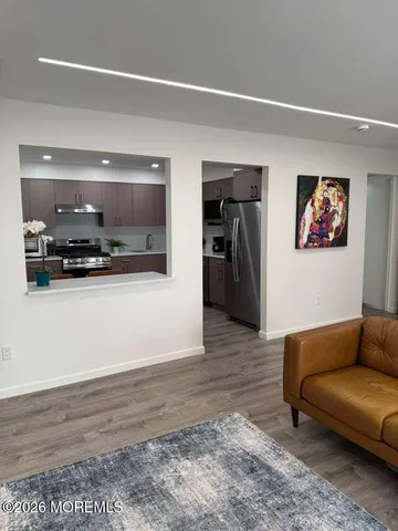 a bedroom with furniture and a flat screen tv