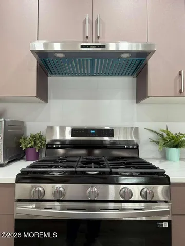 a kitchen with a refrigerator a microwave a sink and cabinets