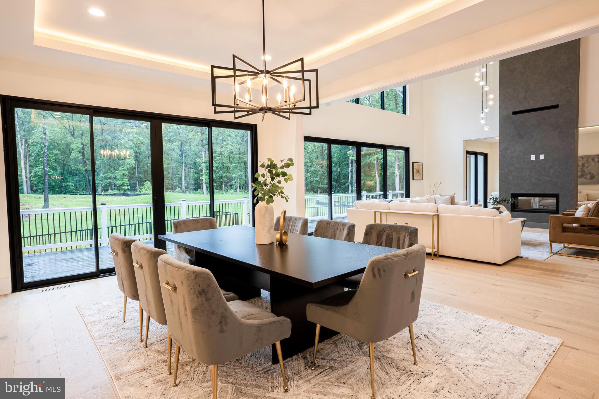 5947 Doyle Road Clifton, VA 20124 - Photo 24 of 69 a dining room with furniture a chandelier and wooden floor