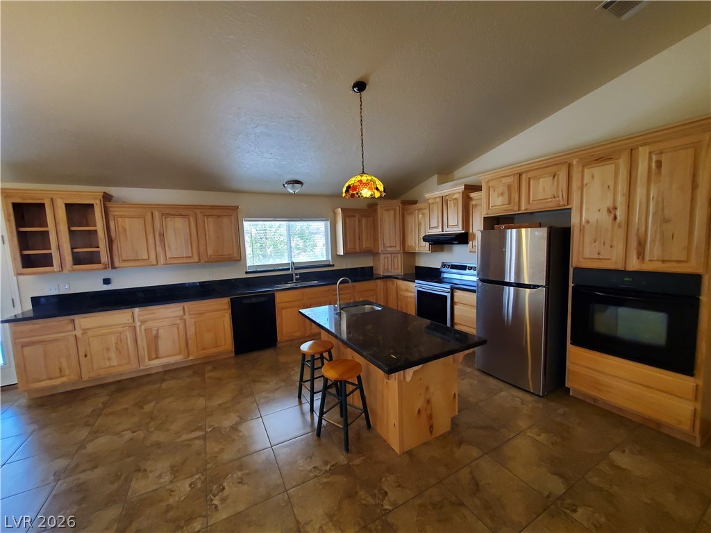 5272 Truman Lane Caliente, NV 89008 - Photo 2 of 43 A spacious culinary haven awaits, showcasing ample cabinetry and modern stainless steel appliances.