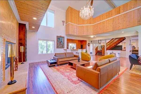 a living room with furniture a rug and a chandelier