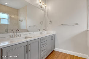 4195 Negal Circle Melbourne, FL 32901 - Photo 12 of 17 a bathroom with a granite countertop sink a mirror and a