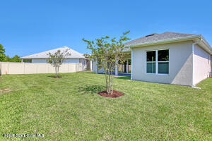 4195 Negal Circle Melbourne, FL 32901 - Photo 3 of 17 a front view of a house with a yard