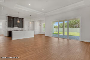 4195 Negal Circle Melbourne, FL 32901 - Photo 6 of 17 a view of an empty room with a window and kitchen view