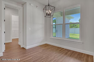 4195 Negal Circle Melbourne, FL 32901 - Photo 8 of 17 wooden floor in an empty room with a window