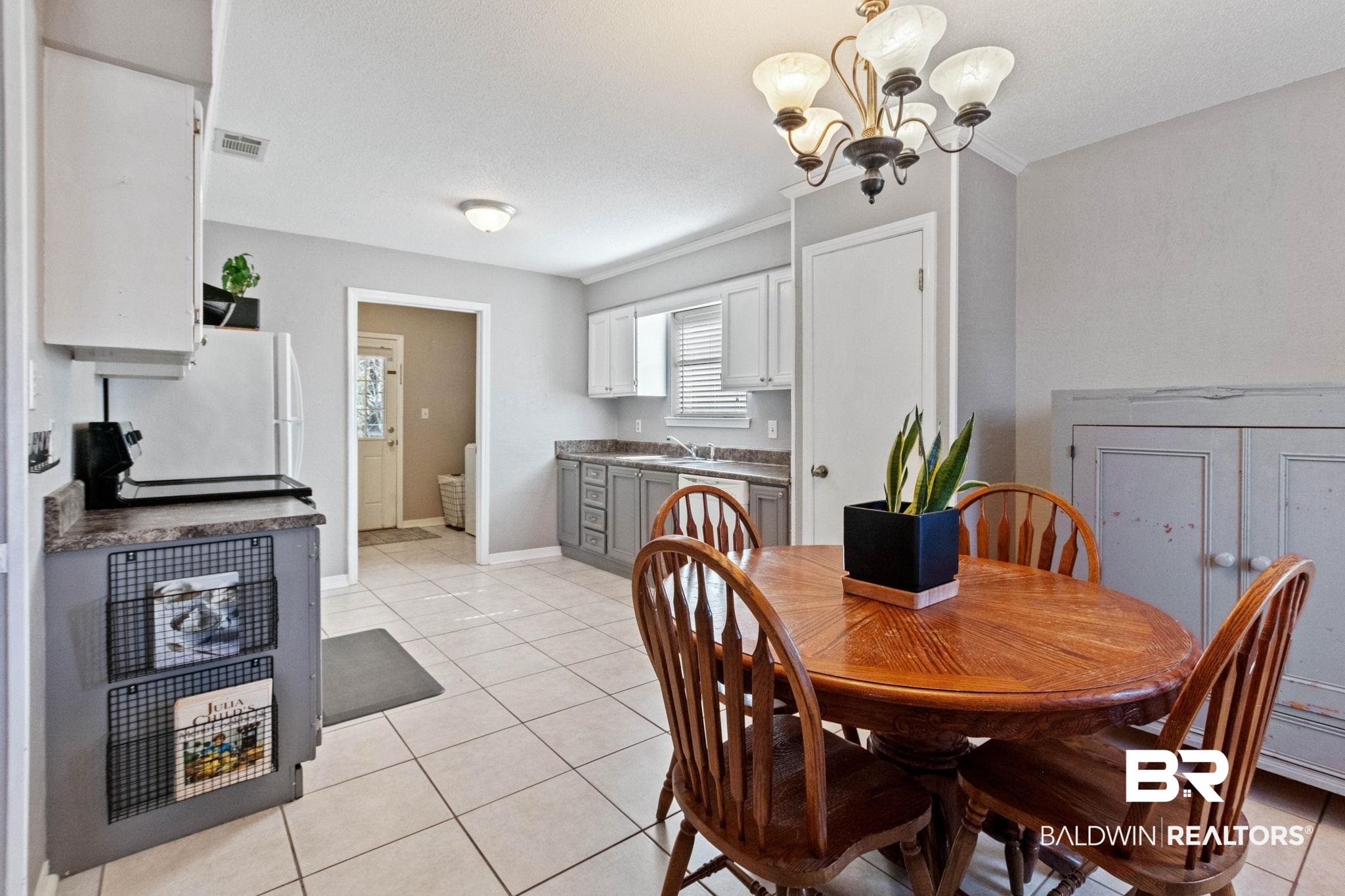 5366 Scanlan Way West Satsuma, AL 36572 - Photo 8 of 43 Dining area featuring light tile patterned floors, a chandelier, and crown molding