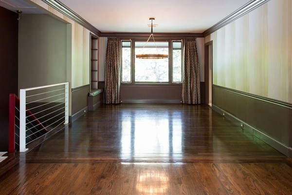 136 Laurel Road Brookline, MA 02467 - Photo 4 of 18 a view of an empty room with wooden floor and a window