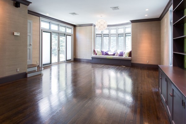 136 Laurel Road Brookline, MA 02467 - Photo 5 of 18 a view of empty room with wooden floor and fan