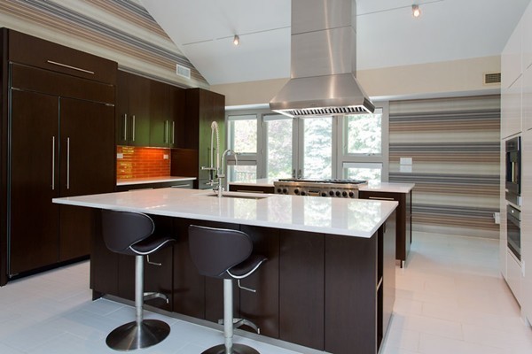 136 Laurel Road Brookline, MA 02467 - Photo 10 of 18 a kitchen with a table chairs and a refrigerator