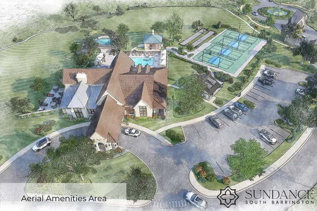 an aerial view of a house with a garden and lake view