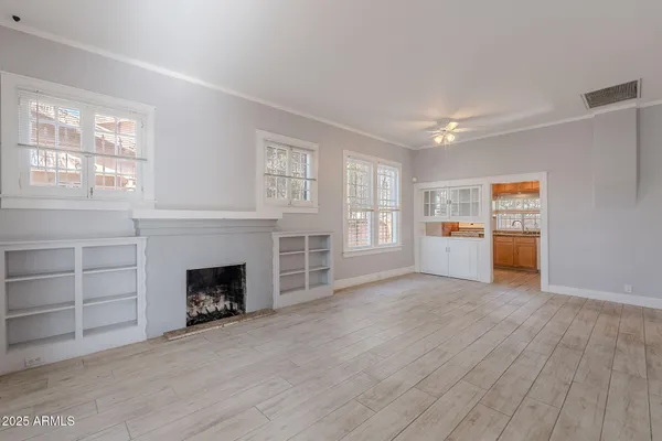 a view of a livingroom with a fireplace and window