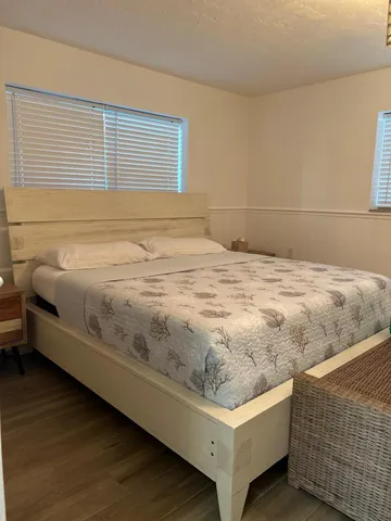 a bedroom with a bed and a night stand