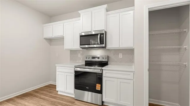 a kitchen with stainless steel appliances granite countertop a sink and wooden cabinets