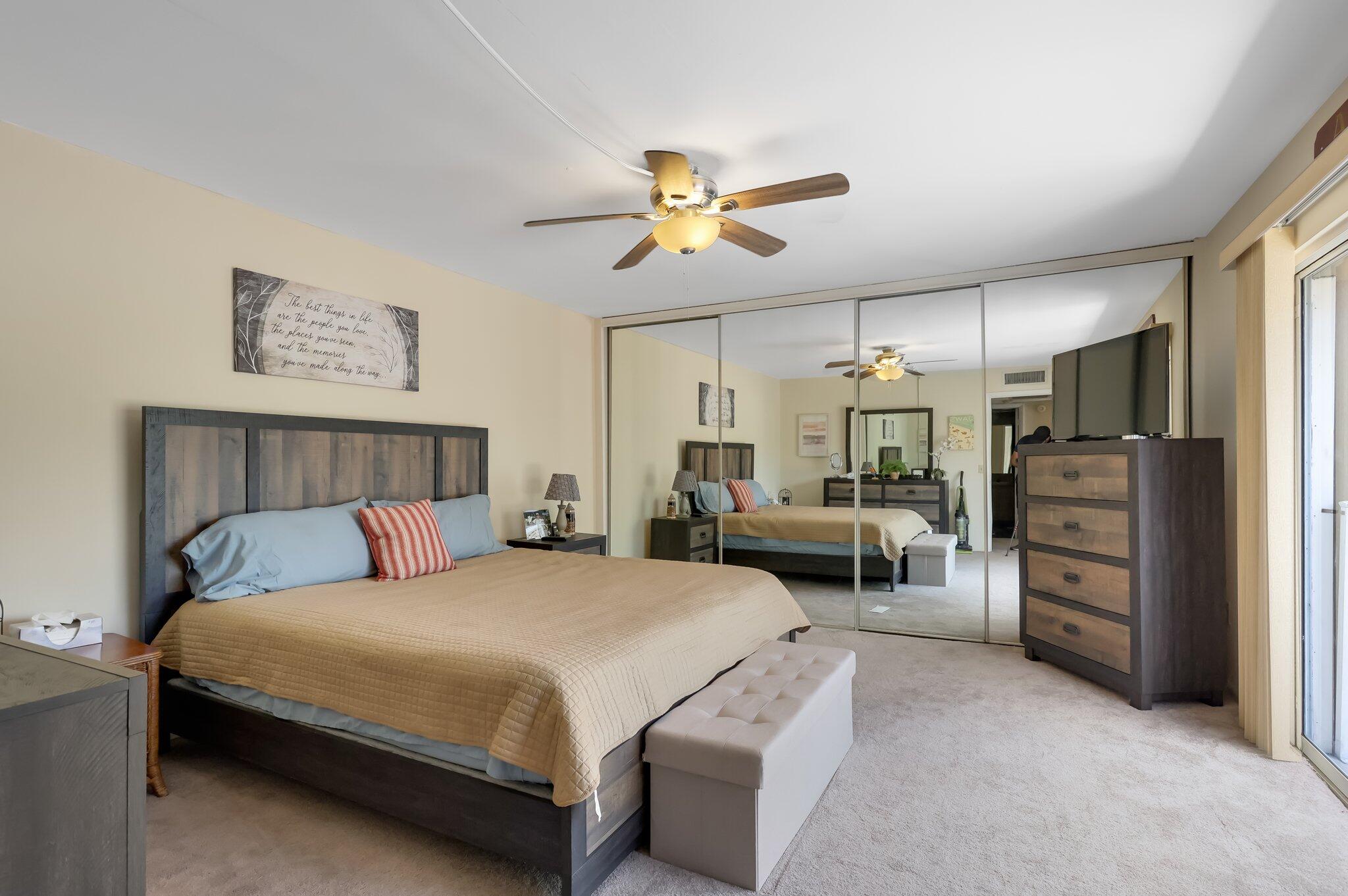 22172 Boca Rancho Drive, Unit B Boca Raton, FL 33428 - Photo 15 of 20 a bedroom with bed couches and a refrigerator
