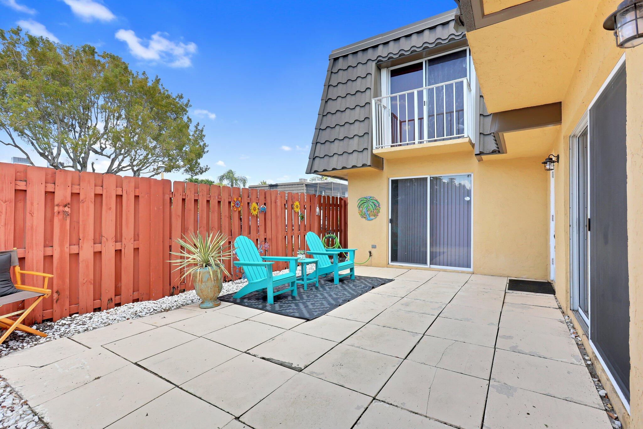 22172 Boca Rancho Drive, Unit B Boca Raton, FL 33428 - Photo 3 of 20 a backyard of a house with chairs and tables