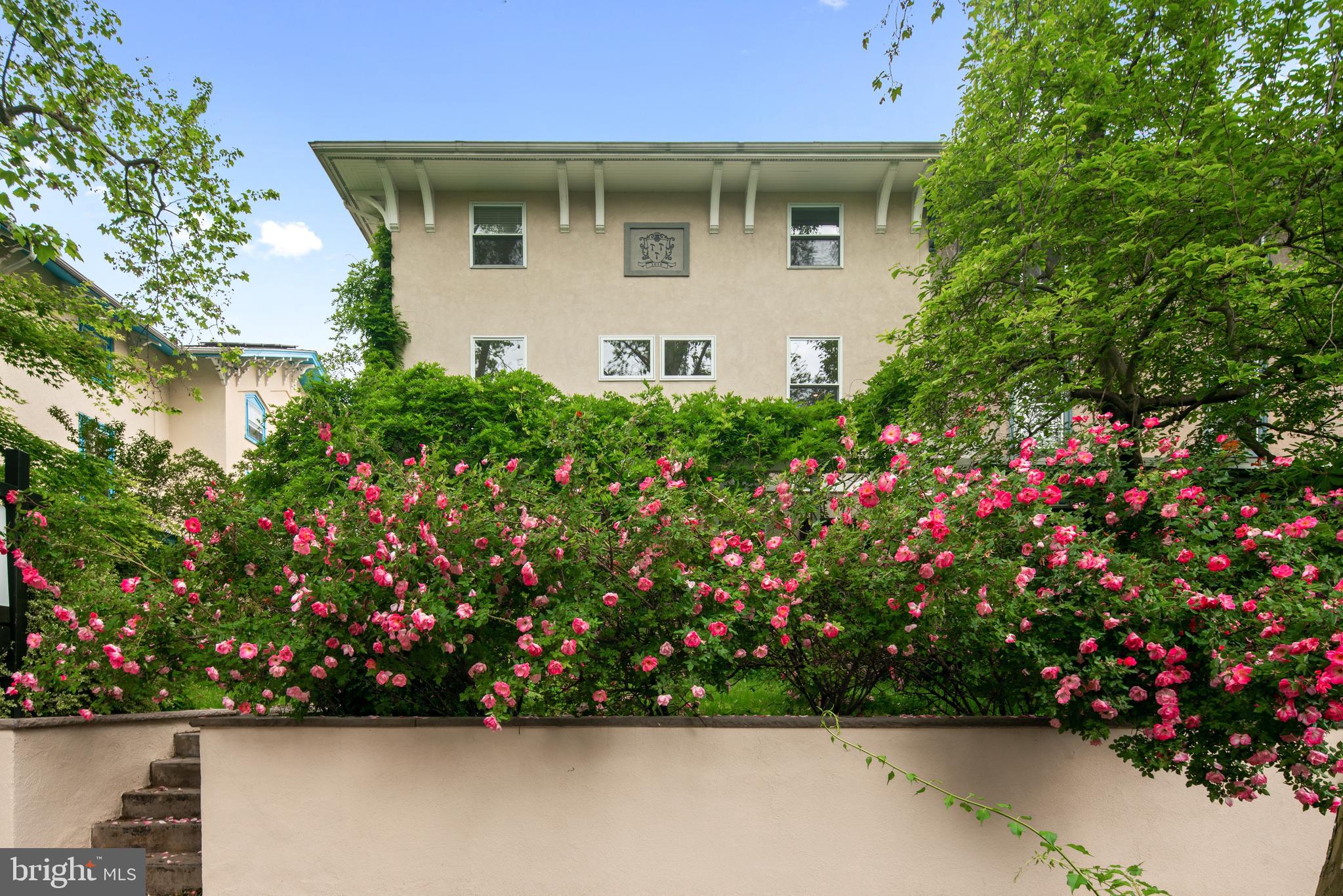 a view of a house with a lot of flower plants