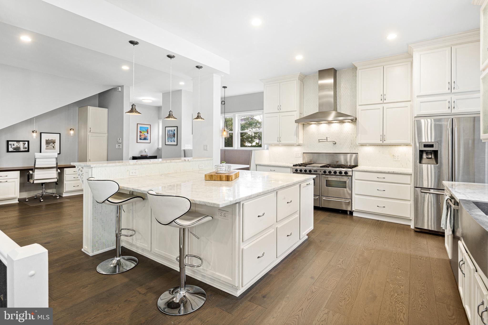 3313 Baring Street Philadelphia, PA 19104 - Photo 18 of 55 a kitchen with stainless steel appliances kitchen island granite countertop a stove a sink and a refrigerator
