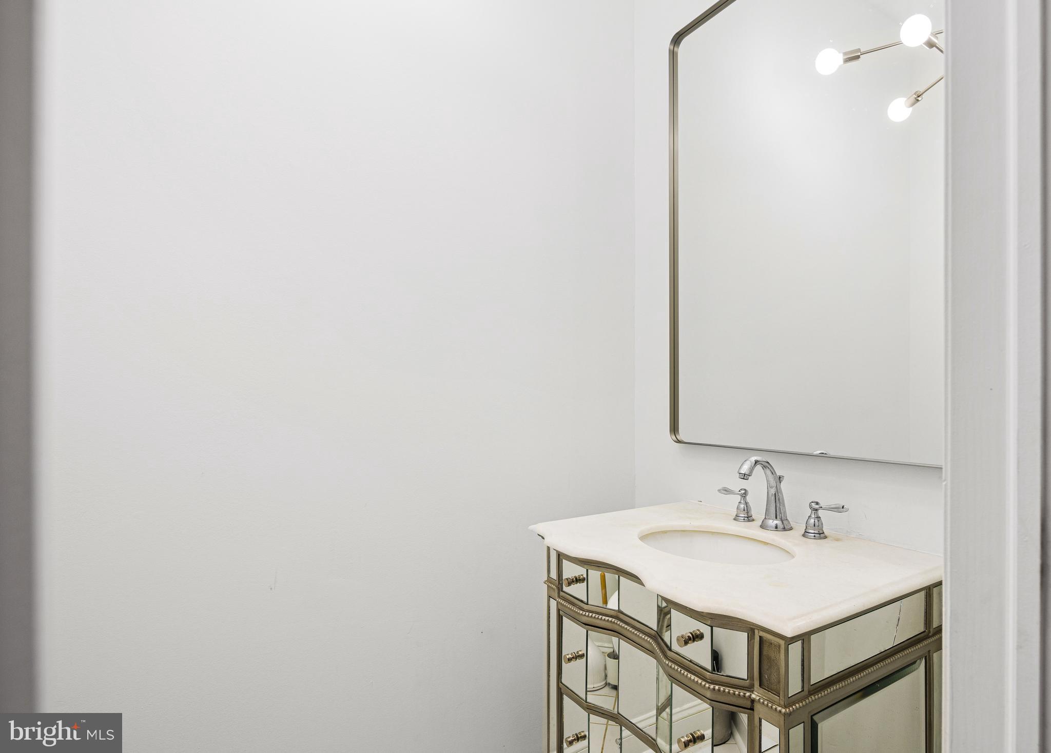 3313 Baring Street Philadelphia, PA 19104 - Photo 25 of 55 a bathroom with a sink and a mirror