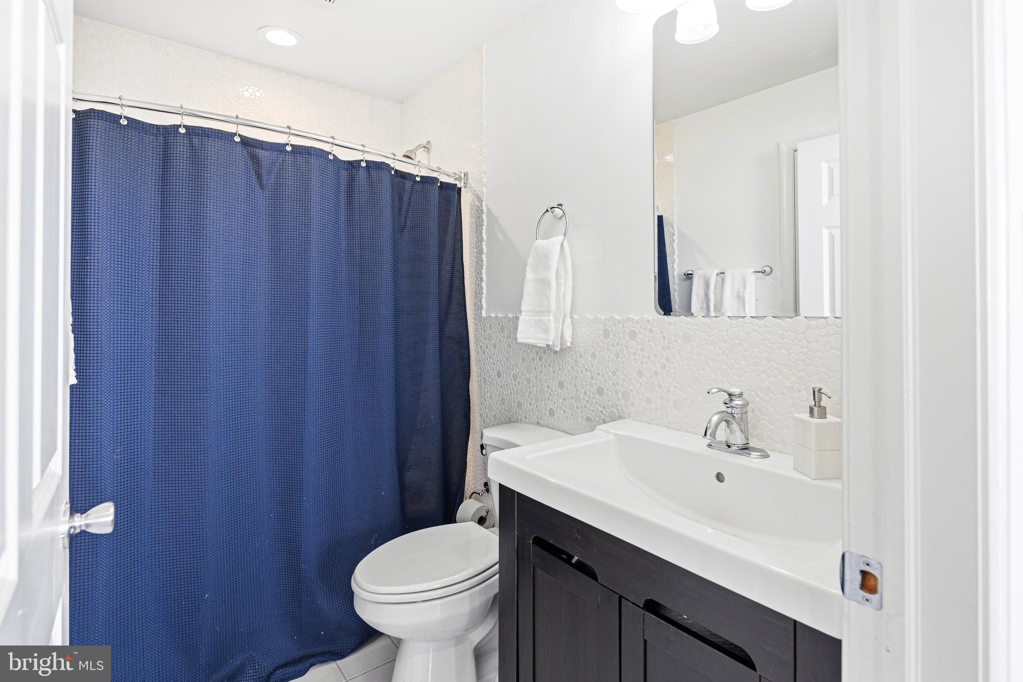 3313 Baring Street Philadelphia, PA 19104 - Photo 28 of 55 a bathroom with a sink a toilet and mirror