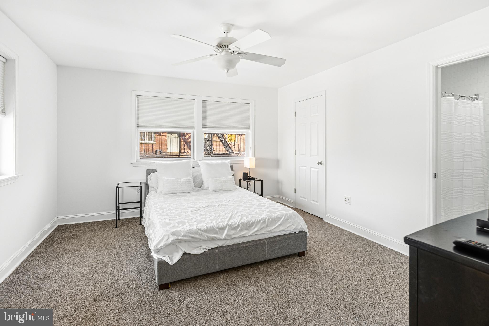 3313 Baring Street Philadelphia, PA 19104 - Photo 41 of 55 a spacious bedroom with a bed and a chandelier