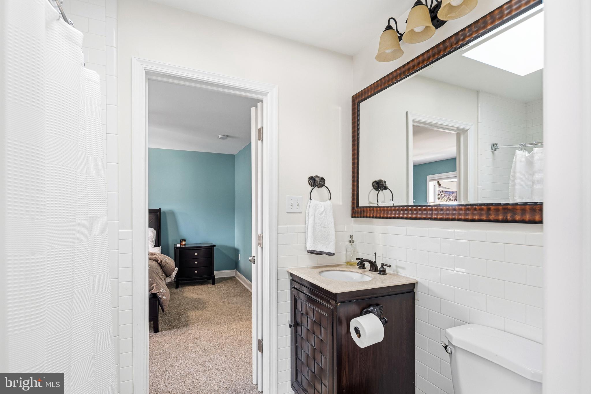 3313 Baring Street Philadelphia, PA 19104 - Photo 45 of 55 a bathroom with a toilet a sink and mirror