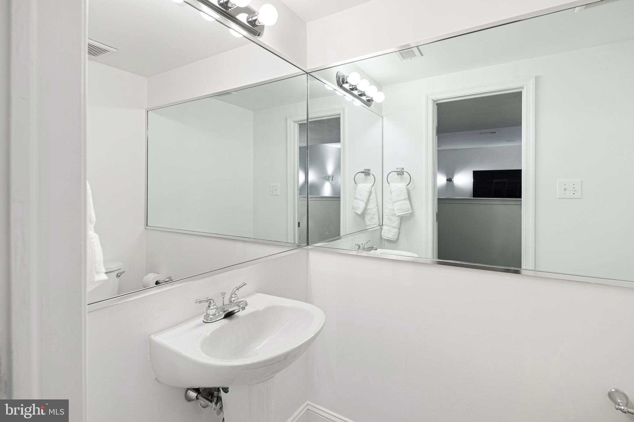 3313 Baring Street Philadelphia, PA 19104 - Photo 52 of 55 a bathroom with a sink and a mirror