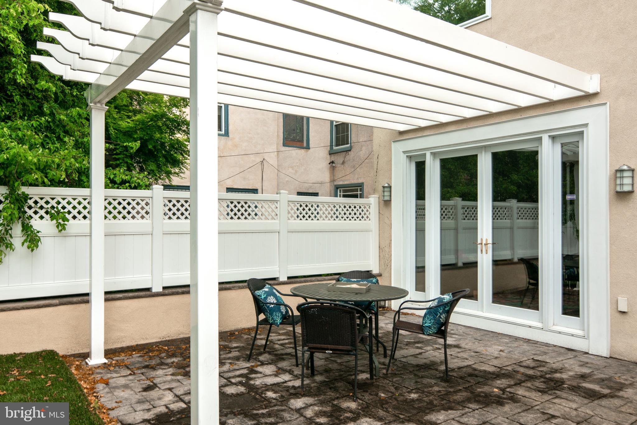 3313 Baring Street Philadelphia, PA 19104 - Photo 53 of 55 a view of a patio with table and chairs with wooden floor and fence