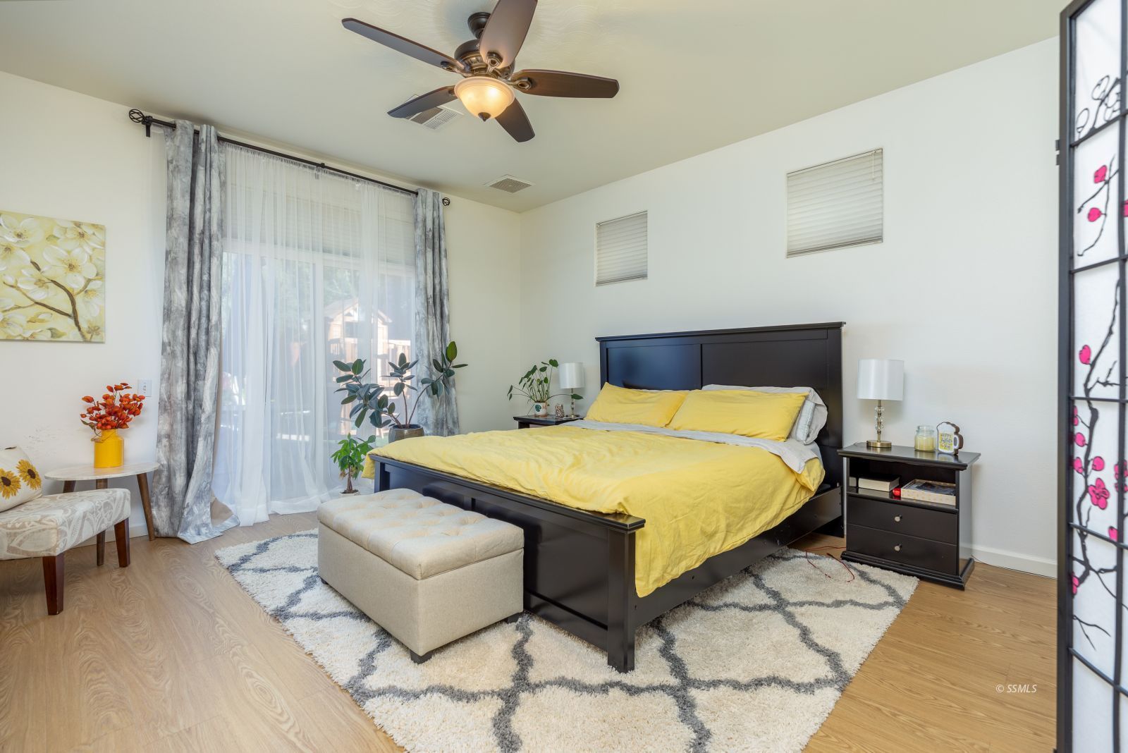 718 Pinon Court Ridgecrest, CA 93555 - Photo 20 of 41 a bedroom with a bed and a chandelier