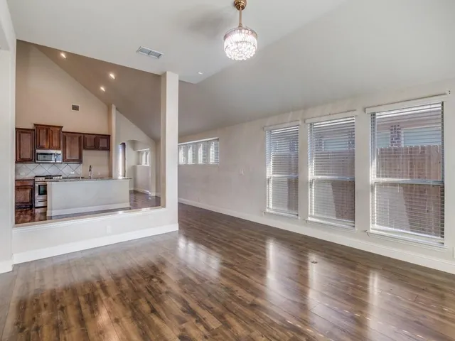 a view of a kitchen with a stove cabinets and a wooden floor