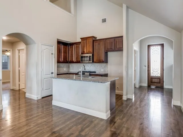 a large white kitchen with a sink